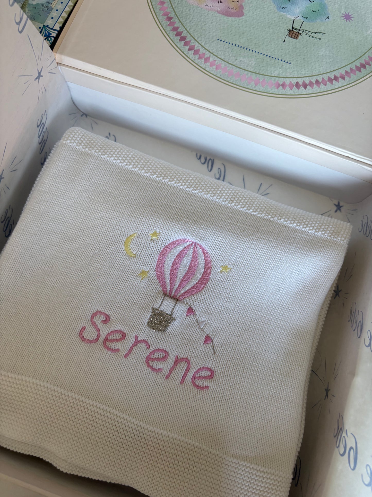 Embroidered blanket with 'Serene' and a hot air balloon design in a decorative keepsake gift box. Perfect gift for newborn